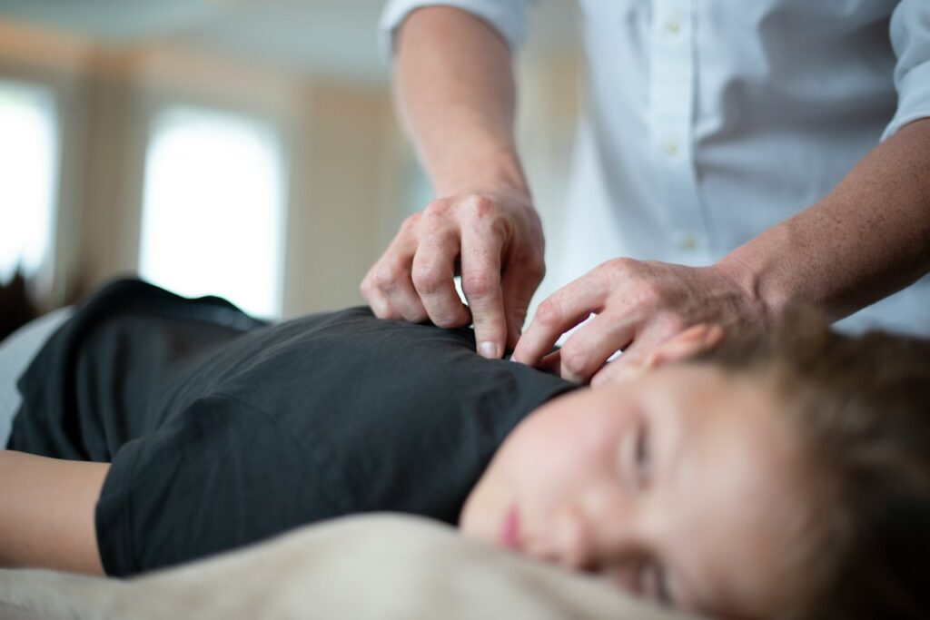 Osteopath treating a patient at Pure Health Osteopath Clinic in Worle, Weston-super-Mare